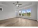 Bedroom featuring a tray ceiling, ceiling fan, hardwood flooring, and windows at 2012 Ripple Park Bnd, Canton, GA 30114