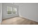 A bright bedroom boasts hardwood floors and two windows letting in natural light at 2012 Ripple Park Bnd, Canton, GA 30114
