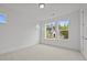 Bright, airy bedroom featuring neutral carpet, white walls, and ample natural light from the large windows at 2012 Ripple Park Bnd, Canton, GA 30114