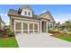 Lovely home showcasing a two-car garage, manicured lawn and complemented by beautiful landscaping at 2012 Ripple Park Bnd, Canton, GA 30114