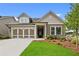 Charming single-Gathering home with a two-car garage, stone accents, manicured lawn and inviting covered entry at 2012 Ripple Park Bnd, Canton, GA 30114