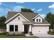 Single-Gathering home with large dormer, two-car garage and colorful landscaping at 2012 Ripple Park Bnd, Canton, GA 30114