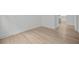 Hallway showcasing beautiful hardwood flooring that leads into an open-concept kitchen at 2012 Ripple Park Bnd, Canton, GA 30114