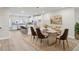 Dining room with a large table and modern chairs, adjacent to the kitchen, great for entertaining at 4659 Red Lion Pl, Lawrenceville, GA 30044