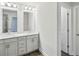 Bright bathroom featuring double vanity with white cabinets, quartz countertop, and modern lighting at 4669 Red Lion Place Pl, Lawrenceville, GA 30044