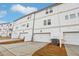 Exterior view of townhomes with white siding, garages and a shared driveway at 4669 Red Lion Place Pl, Lawrenceville, GA 30044