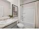 Clean bathroom with a tub, shower, and gray vanity with granite countertop at 8238 Walnut Hall Dr, Fairburn, GA 30213