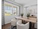 Bright dining area with hardwood floors, large windows, and a view of the backyard at 8238 Walnut Hall Dr, Fairburn, GA 30213