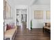 Bright and spacious entryway with hardwood floors, bench, and view into the living area at 8238 Walnut Hall Dr, Fairburn, GA 30213