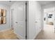 Bright hallway with tile flooring and access to bedrooms at 8238 Walnut Hall Dr, Fairburn, GA 30213