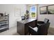 Functional home office with a large desk, two chairs, and plenty of natural light at 8238 Walnut Hall Dr, Fairburn, GA 30213
