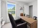 Modern home office with leather chair and wooden desk at 8238 Walnut Hall Dr, Fairburn, GA 30213