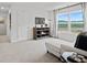 Spacious sitting area with sectional sofa, large window, and storage at 8238 Walnut Hall Dr, Fairburn, GA 30213