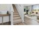 Elegant carpeted staircase with a view into the living room area at 8238 Walnut Hall Dr, Fairburn, GA 30213