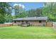 Spacious backyard with a well-maintained lawn, wooden deck, and fenced perimeter at 1167 Mcclung Rd, Hiram, GA 30141