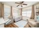 Bedroom featuring a crib, armchair, and ample natural light at 1167 Mcclung Rd, Hiram, GA 30141