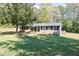 Ranch house with a large front yard and mature trees at 1167 Mcclung Rd, Hiram, GA 30141