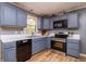 Cozy kitchen with blue cabinets, stainless steel appliances, and a window offering natural light at 1167 Mcclung Rd, Hiram, GA 30141