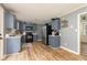 Spacious kitchen featuring blue cabinets, stainless steel appliances, and wood-look flooring at 1167 Mcclung Rd, Hiram, GA 30141