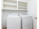 Laundry room with washer, dryer, and overhead shelving at 1167 Mcclung Rd, Hiram, GA 30141