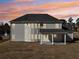 Exterior of a two-story home with a covered patio and spacious backyard at sunset at 1421 Stephens View Dr, Loganville, GA 30052