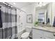 Well-lit bathroom featuring a shower-tub combo, granite vanity, and modern fixtures at 1421 Stephens View Dr, Loganville, GA 30052