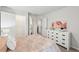 Bright bedroom featuring a soft bed, white dresser, and closet at 1421 Stephens View Dr, Loganville, GA 30052