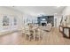 Dining area leading to Gathering room with fireplace, large windows, and backyard access at 1421 Stephens View Dr, Loganville, GA 30052