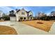 Two-story house with beige siding, black windows, and a large front yard at 1421 Stephens View Dr, Loganville, GA 30052