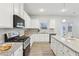 Well-equipped kitchen with granite countertops and white cabinetry at 1421 Stephens View Dr, Loganville, GA 30052