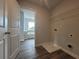 Laundry room with washer/dryer hookups and built-in shelving at 1421 Stephens View Dr, Loganville, GA 30052