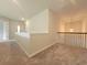 Spacious loft area with carpet and railing overlooking the living room at 1421 Stephens View Dr, Loganville, GA 30052