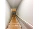 Staircase leading down to the basement, showing unfinished steps and concrete walls at 5547 Bent Grass Way, Douglasville, GA 30135