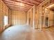 Unfinished basement featuring wood frame, exposed insulation, and natural light from the basement window at 5547 Bent Grass Way, Douglasville, GA 30135