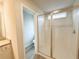 Bathroom with granite countertop, framed shower, wood-look floors, and an adjacent toilet room at 5547 Bent Grass Way, Douglasville, GA 30135