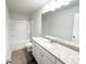 Bathroom featuring a granite countertop, vinyl flooring, and a shower-tub combo at 5547 Bent Grass Way, Douglasville, GA 30135