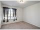 Spacious bedroom with neutral carpeting and large window at 7711 Cabrini Pl, Fairburn, GA 30213