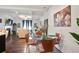 Bright dining area with glass table and four chairs, adjacent to living room at 7711 Cabrini Pl, Fairburn, GA 30213