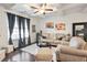 Living room with coffered ceiling, gray curtains, and hardwood floors at 7711 Cabrini Pl, Fairburn, GA 30213