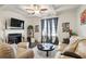 Spacious living room with fireplace and coffered ceiling at 7711 Cabrini Pl, Fairburn, GA 30213