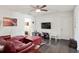 Comfortable loft area featuring a red leather sectional and a flat-screen TV at 7711 Cabrini Pl, Fairburn, GA 30213