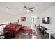 Spacious loft area with red leather sectional and flat-screen TV at 7711 Cabrini Pl, Fairburn, GA 30213