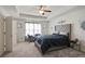 Bright and airy main bedroom with a comfy seating area at 7711 Cabrini Pl, Fairburn, GA 30213