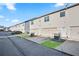 Rear view of townhomes with attached garages and parking at 7711 Cabrini Pl, Fairburn, GA 30213