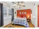 Bedroom with orange accent wall, hardwood floors, and a ceiling fan at 785 Ponce De Leon Ne Pl # 8, Atlanta, GA 30306