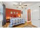 Bedroom with orange accent wall, hardwood floors, and ceiling fan at 785 Ponce De Leon Ne Pl # 8, Atlanta, GA 30306