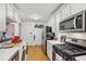 Modern kitchen with white cabinets, stainless steel appliances, and wood flooring at 785 Ponce De Leon Ne Pl # 8, Atlanta, GA 30306