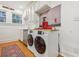 Bright kitchen with washer and dryer, wood flooring and modern appliances at 785 Ponce De Leon Ne Pl # 8, Atlanta, GA 30306