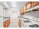 Kitchen features wood cabinets, gray counters, and dining area view at 2776 Vinings Central Se Dr # 19, Atlanta, GA 30339