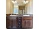 Double vanity bathroom with dark brown cabinets and granite countertop at 5105 Deepwater Cv, Acworth, GA 30101
